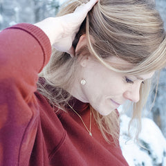 Delicate hand-stamped Alaska earrings and necklace, displayed as wearing